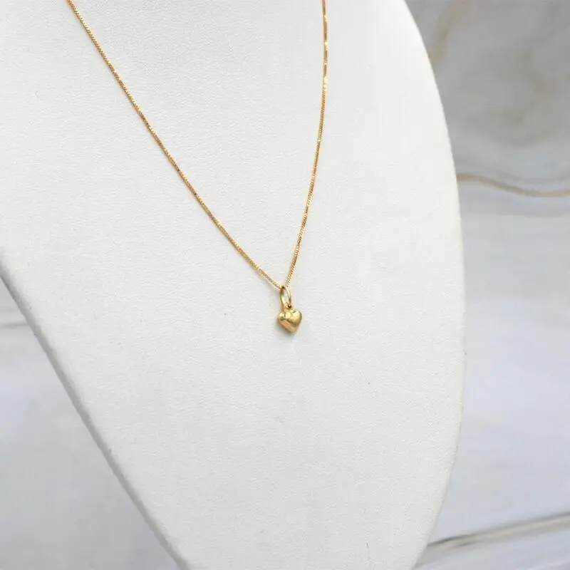 Conjunto de cadena y colgante corazón en oro 18k, joya delicada para uso diario.